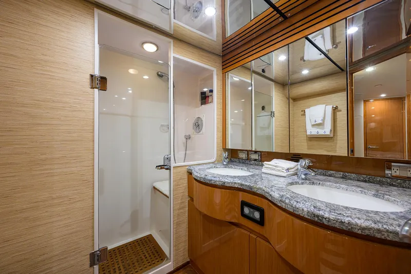 Goin Deep Yacht Photos Pics Luxurious bathroom in 2014 Bertram 700 yacht with shower and double sink vanity.