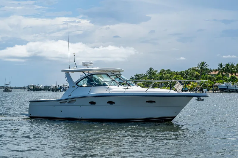  Yacht Photos Pics 2008 Tiara Yachts 3200 Open cruising on a sunny day near a tropical shoreline.