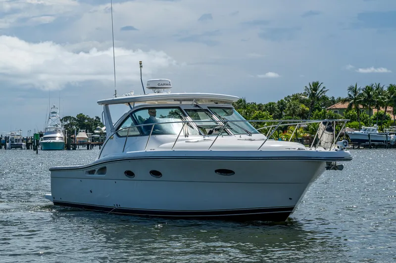  Yacht Photos Pics 2008 Tiara Yachts 3200 Open cruising on a sunny day, surrounded by lush greenery.