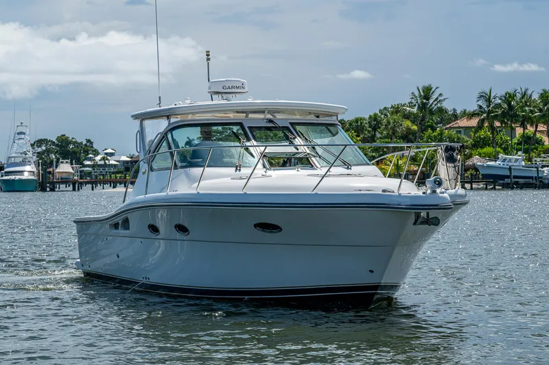  Yacht Photos Pics 2008 Tiara Yachts 3200 Open cruising on a sunny day near a marina.