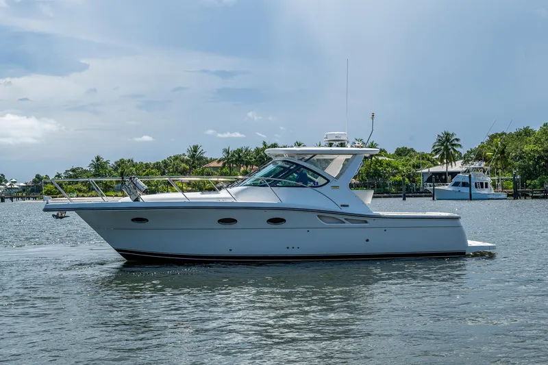  Yacht Photos Pics 2008 Tiara Yachts 3200 Open cruising on a calm waterway with lush greenery.