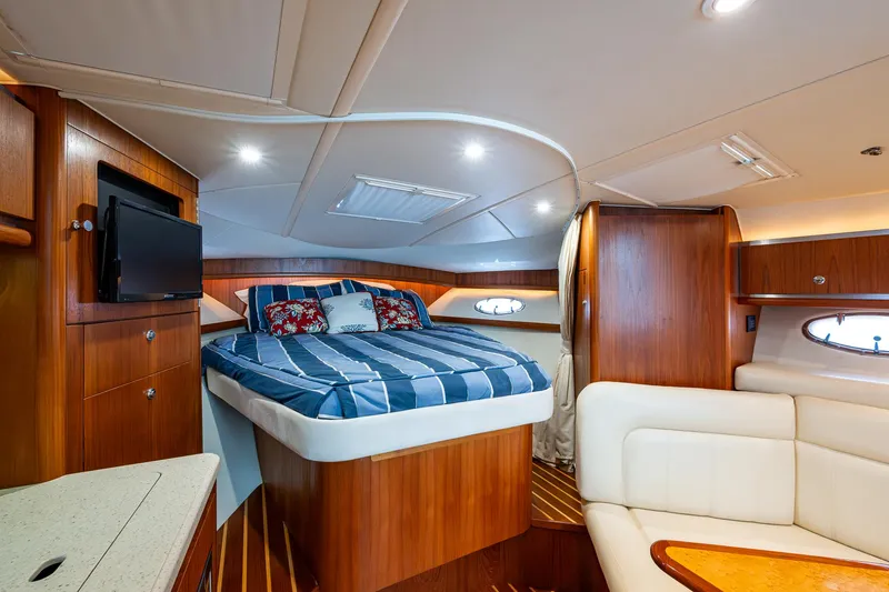  Yacht Photos Pics Luxurious 2008 Tiara Yachts 3200 Open cabin interior with bed, TV, and seating area.