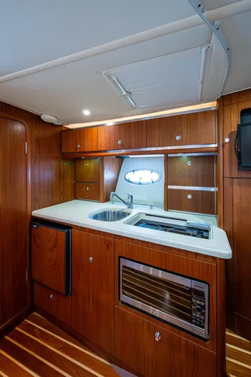  Yacht Photos Pics 2008 Tiara Yachts 3200 Open galley with wood cabinetry, sink, and microwave.