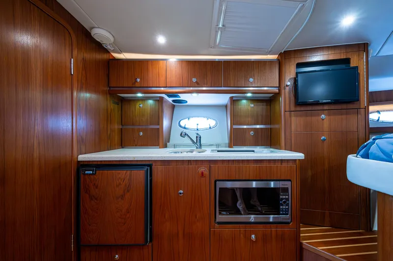  Yacht Photos Pics Luxurious 2008 Tiara Yachts 3200 Open interior with wood cabinetry and modern amenities.