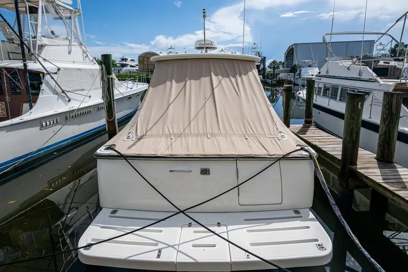  Yacht Photos Pics 2008 Tiara Yachts 3200 Open docked with beige cover, surrounded by other boats.