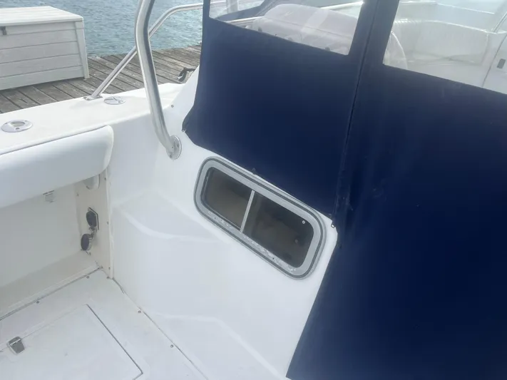  Yacht Photos Pics Boston Whaler 295 Conquest WA 2002 boat interior with blue canvas and window.