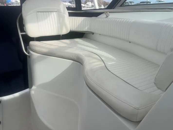  Yacht Photos Pics Interior seating of 2002 Boston Whaler 295 Conquest WA boat, featuring white cushioned seats.