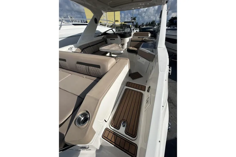  Yacht Photos Pics 2017 Sea Ray SLX 310 Outboard interior with beige seating and wood accents.