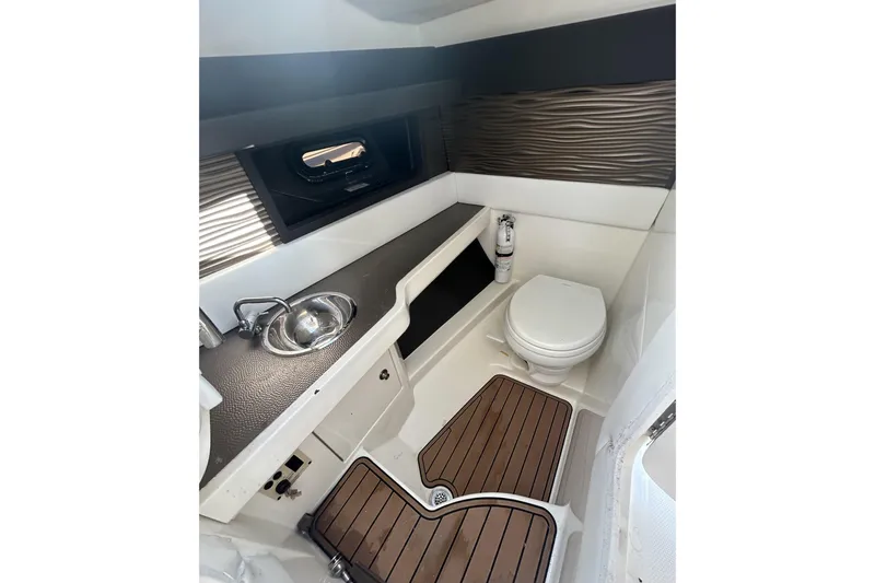  Yacht Photos Pics 2017 Sea Ray SLX 310 Outboard boat bathroom with sink, toilet, and wood flooring.