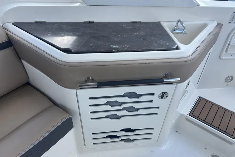  Yacht Photos Pics 2017 Sea Ray SLX 310 Outboard boat interior with sink and storage area.