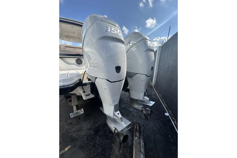  Yacht Photos Pics Twin outboard engines on a 2017 Sea Ray SLX 310 boat, parked outdoors.