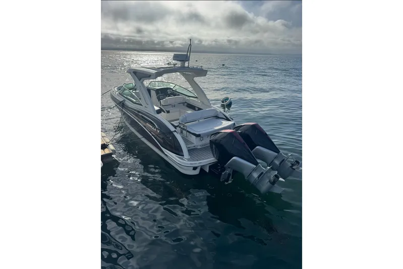  Yacht Photos Pics 2022 Formula 310 Bowrider OB boat on calm water, rear view with dual outboard engines.