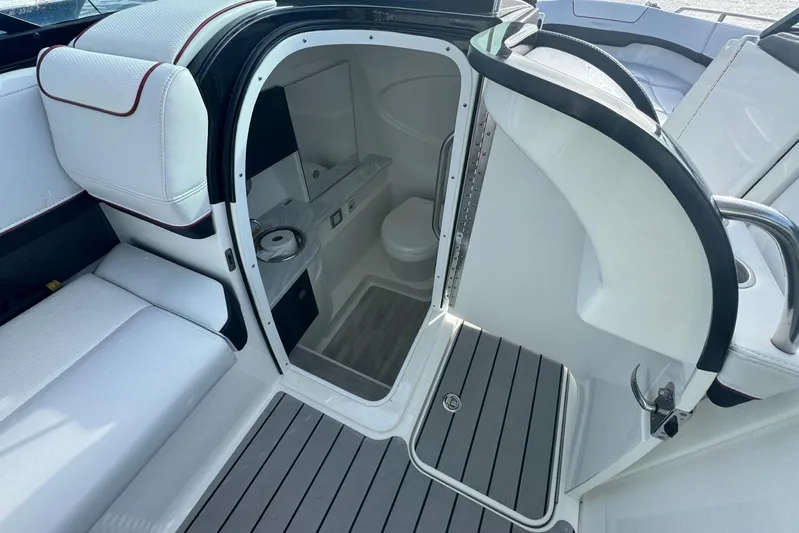  Yacht Photos Pics 2022 Formula 310 Bowrider OB interior with seating and compact restroom.