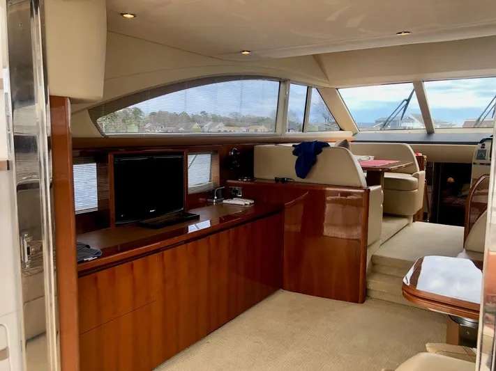 Ahdorned Yacht Photos Pics Luxurious interior of 2009 Princess F54 yacht with elegant wood finishes and seating area.