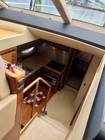 Ahdorned Yacht Photos Pics Interior view of 2009 Princess F54 yacht, featuring a compact kitchen and staircase.