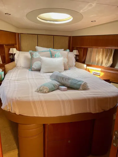 Ahdorned Yacht Photos Pics Luxurious bedroom interior of 2009 Princess F54 yacht with elegant bedding and natural light.