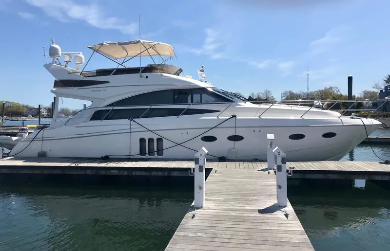 Ahdorned Yacht Photos Pics Luxury 2009 Princess F54 yacht docked at marina under clear blue sky.