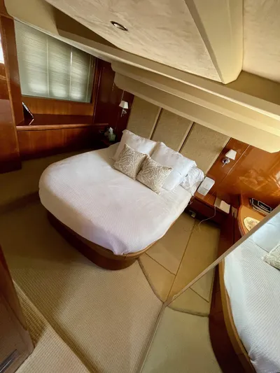 Ahdorned Yacht Photos Pics Luxurious bedroom interior of 2009 Princess F54 yacht with elegant bedding and wood accents.