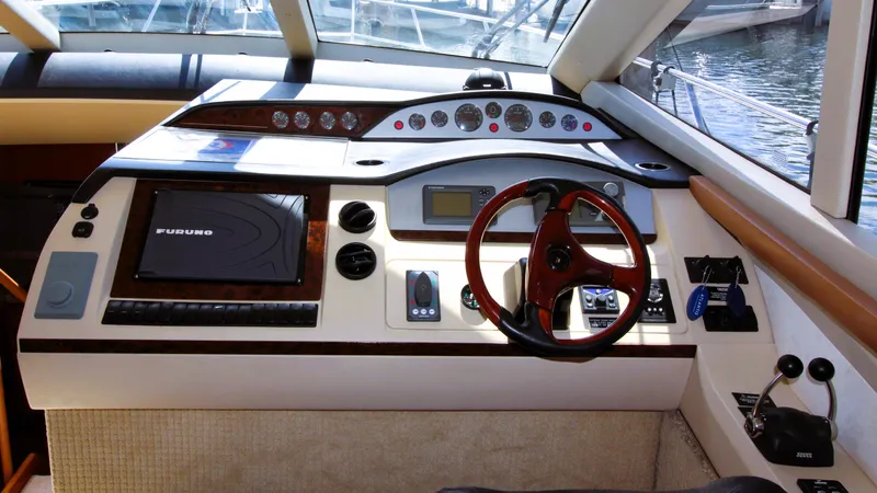 Ahdorned Yacht Photos Pics Luxurious 2009 Princess F54 yacht cockpit with advanced navigation controls and steering wheel.