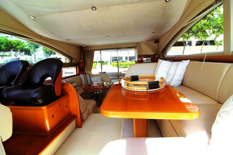 Ahdorned Yacht Photos Pics Luxurious interior of a 2009 Princess F54 yacht with elegant seating and wooden table.