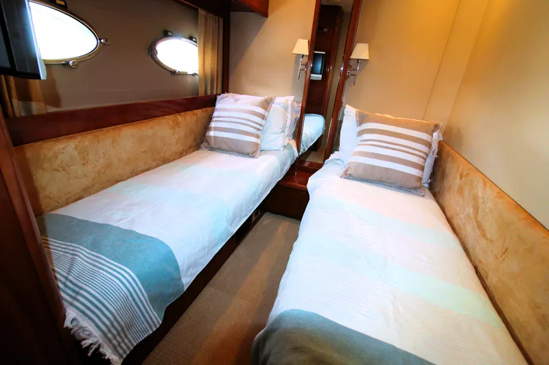Ahdorned Yacht Photos Pics Twin beds in a 2009 Princess F54 yacht cabin with striped bedding.