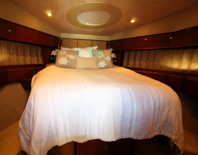 Ahdorned Yacht Photos Pics Luxurious bedroom interior of 2009 Princess F54 yacht with elegant bedding and ambient lighting.