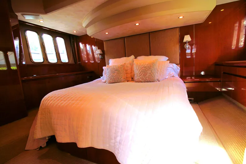 Ahdorned Yacht Photos Pics Luxurious bedroom interior of 2009 Princess F54 yacht with elegant bedding and wood paneling.