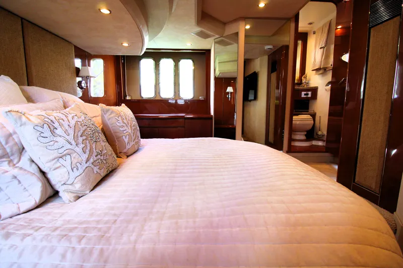 Ahdorned Yacht Photos Pics Luxurious bedroom interior of 2009 Princess F54 yacht with elegant bedding and ensuite bathroom.