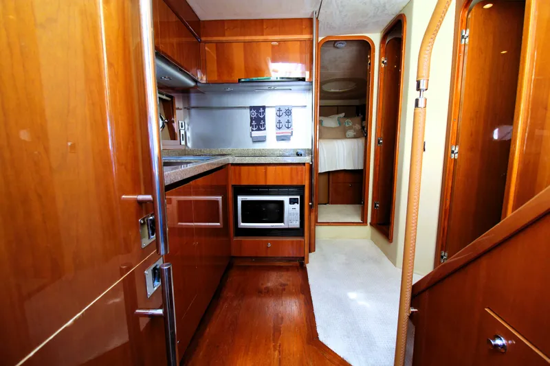 Ahdorned Yacht Photos Pics Luxurious 2009 Princess F54 yacht interior with wood finish, kitchenette, and cozy bedroom.