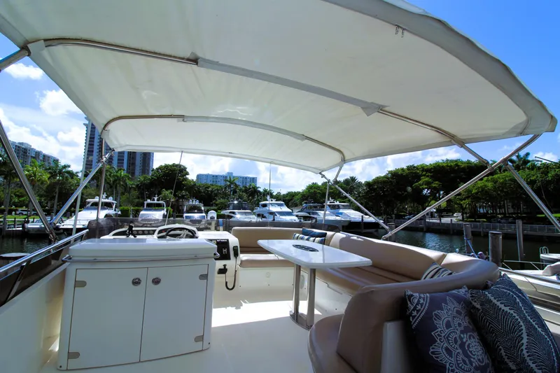 Ahdorned Yacht Photos Pics Luxurious 2009 Princess F54 yacht interior with seating and helm, docked at marina.