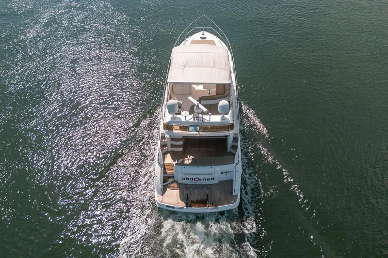 Ahdorned Yacht Photos Pics Aerial view of 2009 Princess F54 yacht cruising on open water.