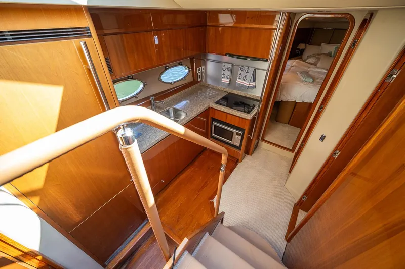 Ahdorned Yacht Photos Pics Luxurious 2009 Princess F54 yacht interior with modern kitchen and cozy bedroom.
