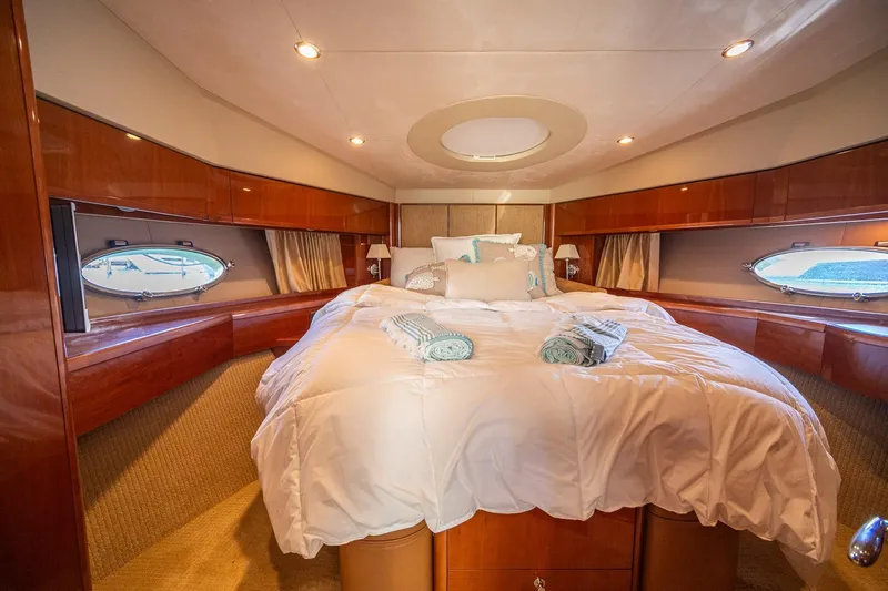 Ahdorned Yacht Photos Pics Luxurious 2009 Princess F54 yacht bedroom with elegant wood paneling and plush bedding.