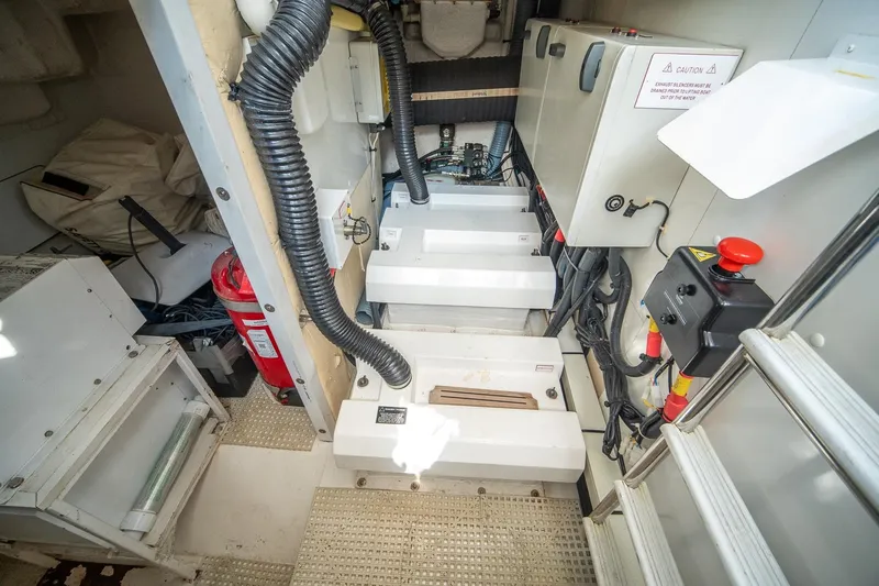 Ahdorned Yacht Photos Pics Engine room of a 2009 Princess F54 yacht, featuring equipment and safety gear.