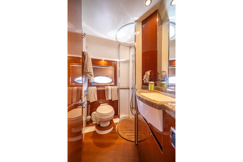 Ahdorned Yacht Photos Pics Luxurious bathroom in 2009 Princess F54 yacht with modern fixtures and elegant wood accents.