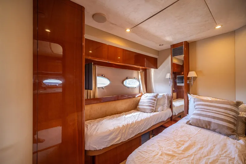 Ahdorned Yacht Photos Pics Luxurious 2009 Princess F54 yacht cabin with elegant wood finishes and cozy bedding.