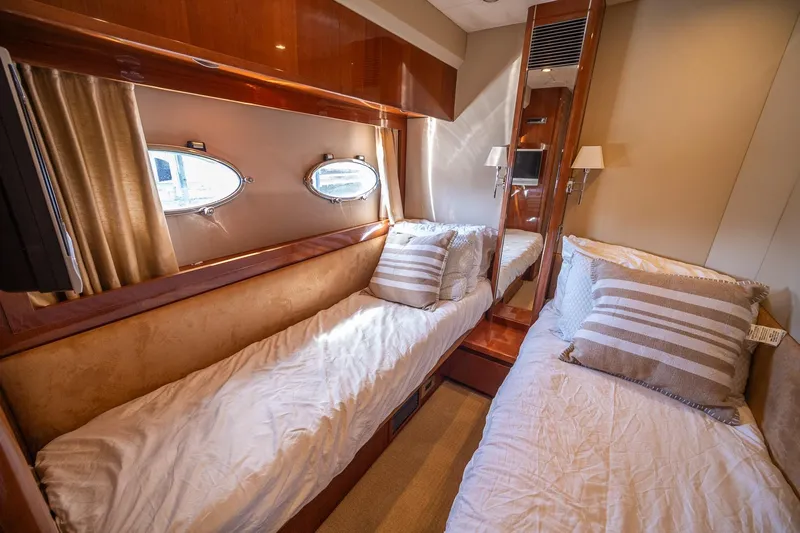 Ahdorned Yacht Photos Pics Luxurious cabin interior of 2009 Princess F54 yacht with twin beds and porthole windows.