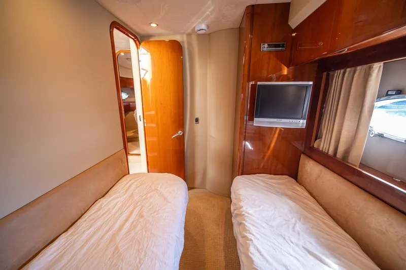 Ahdorned Yacht Photos Pics Luxurious 2009 Princess F54 yacht cabin with twin beds and wall-mounted TV.