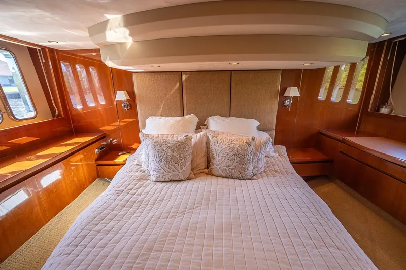 Ahdorned Yacht Photos Pics Luxurious bedroom interior of 2009 Princess F54 yacht with elegant wood paneling.