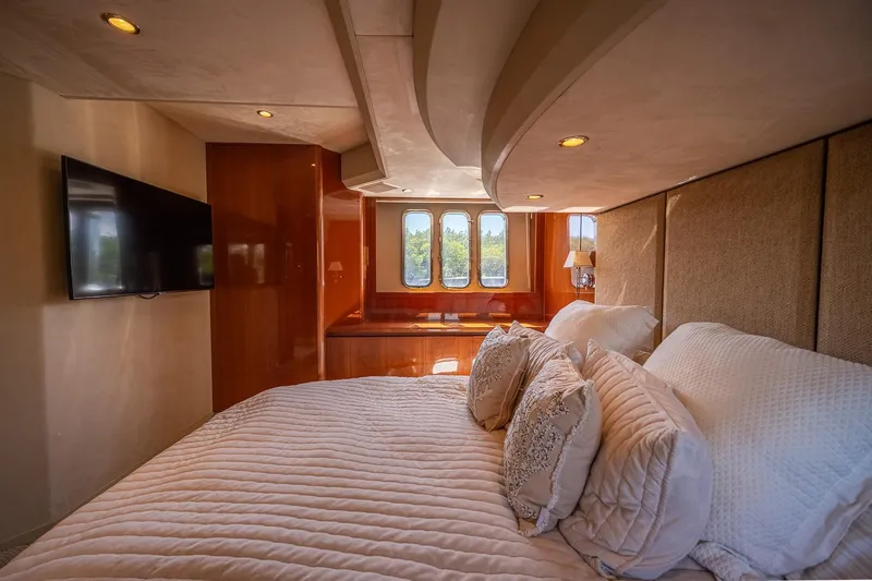 Ahdorned Yacht Photos Pics Luxurious bedroom interior of 2009 Princess F54 yacht with elegant bedding and wall-mounted TV.