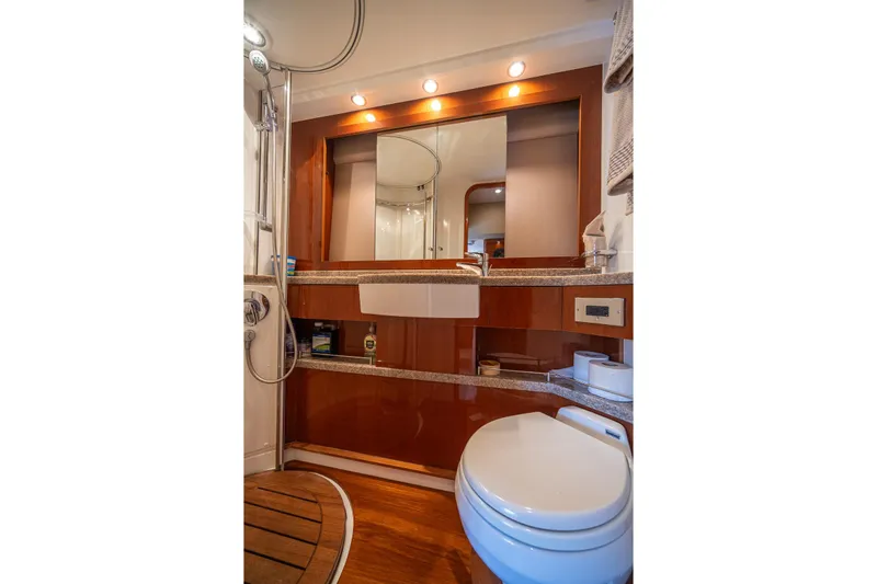Ahdorned Yacht Photos Pics Luxurious yacht bathroom with modern fixtures, wooden accents, and elegant lighting, Princess F54 2009 model.