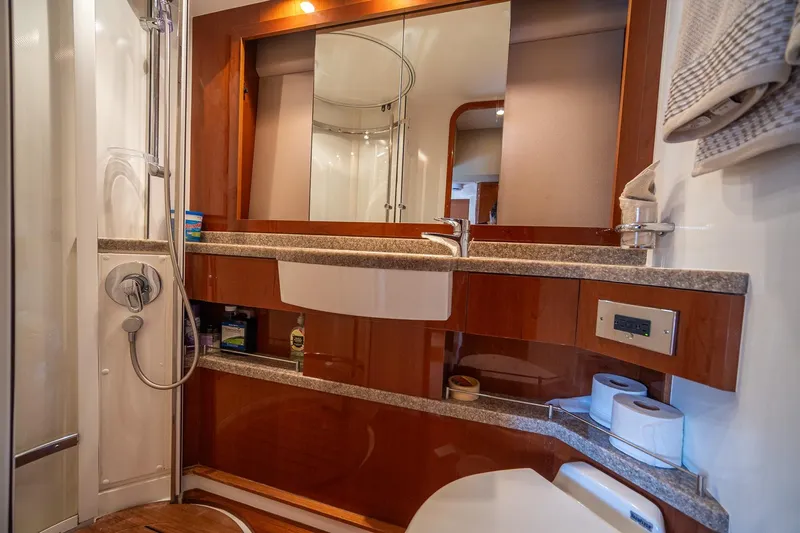 Ahdorned Yacht Photos Pics Luxurious bathroom in 2009 Princess F54 yacht with modern fixtures and elegant wood accents.
