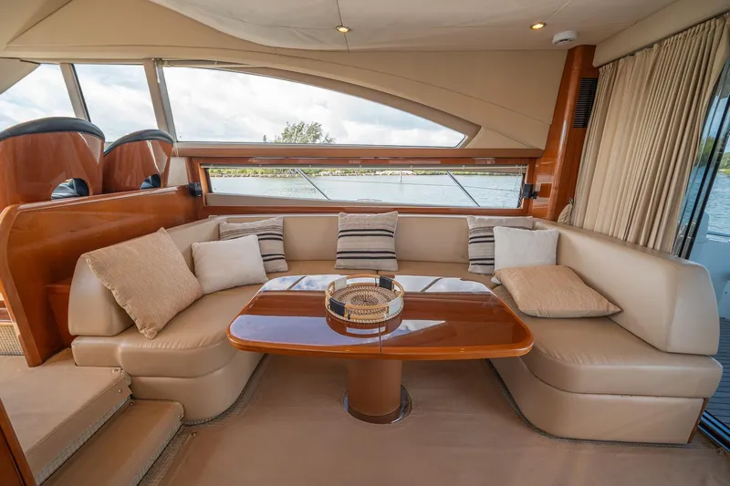 Ahdorned Yacht Photos Pics Luxurious interior of 2009 Princess F54 yacht with elegant seating and wooden table.