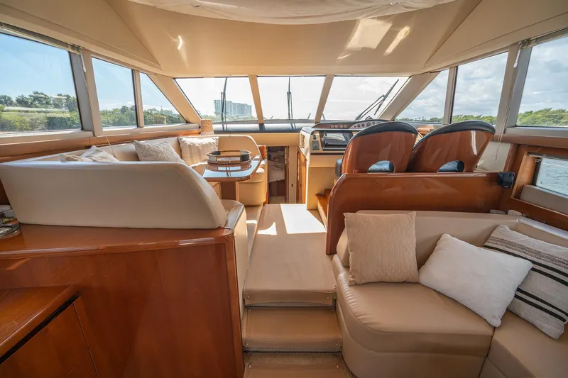 Ahdorned Yacht Photos Pics Luxurious interior of 2009 Princess F54 yacht with plush seating and panoramic windows.