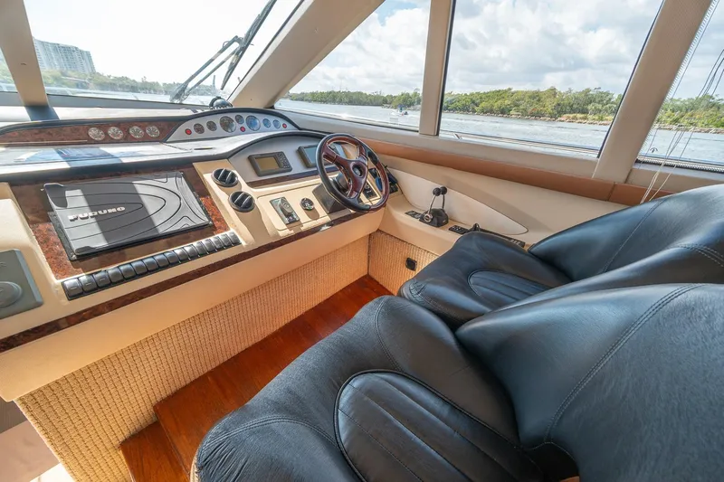 Ahdorned Yacht Photos Pics Luxurious 2009 Princess F54 yacht cockpit with leather seats and advanced navigation controls.