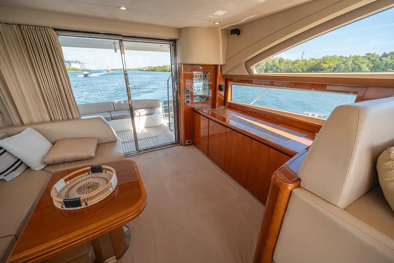Ahdorned Yacht Photos Pics Luxurious interior of 2009 Princess F54 yacht with elegant wood finishes and scenic water view.