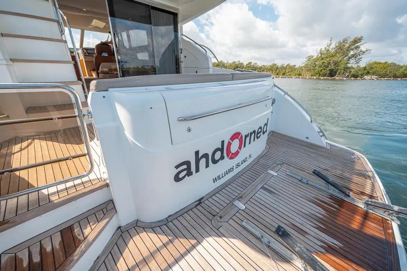 Ahdorned Yacht Photos Pics Luxury Princess F54 yacht, 2009 model, docked with wooden deck and scenic water view.