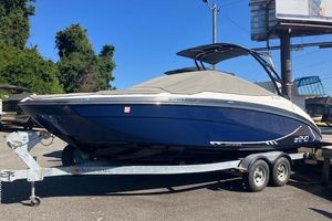2016 Yamaha Boats AR240 on trailer, blue hull, covered, parked outdoors.
