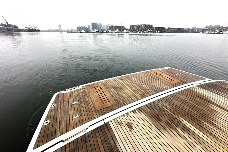 Cyctrade Yacht Photos Pics Wooden deck of a 2017 Prestige 500 yacht overlooking a calm harbor.