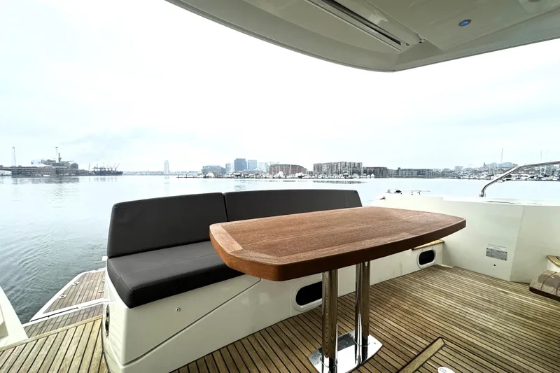 Cyctrade Yacht Photos Pics Luxury 2017 Prestige 500 yacht deck with wooden table and waterfront view.